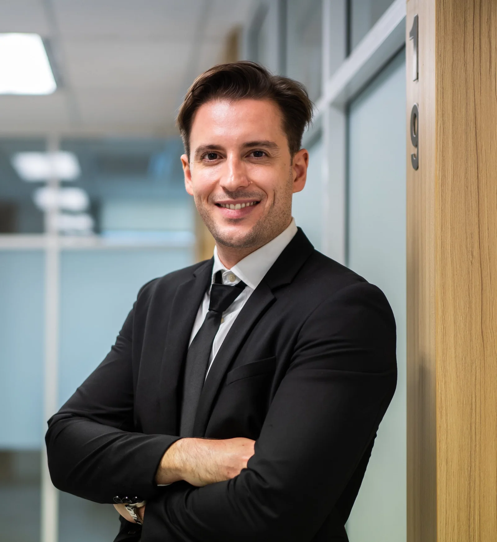 Man in black suit smiling